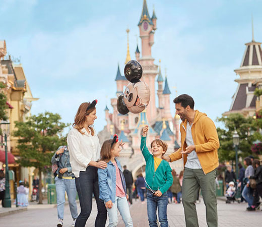 Happy family enjoying Disneyland Paris after comfortable CDG airport transfer with Easy Go Shuttle - 35 minutes from Paris